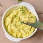 Spreadable roasted garlic butter prepared for serving in a bowl