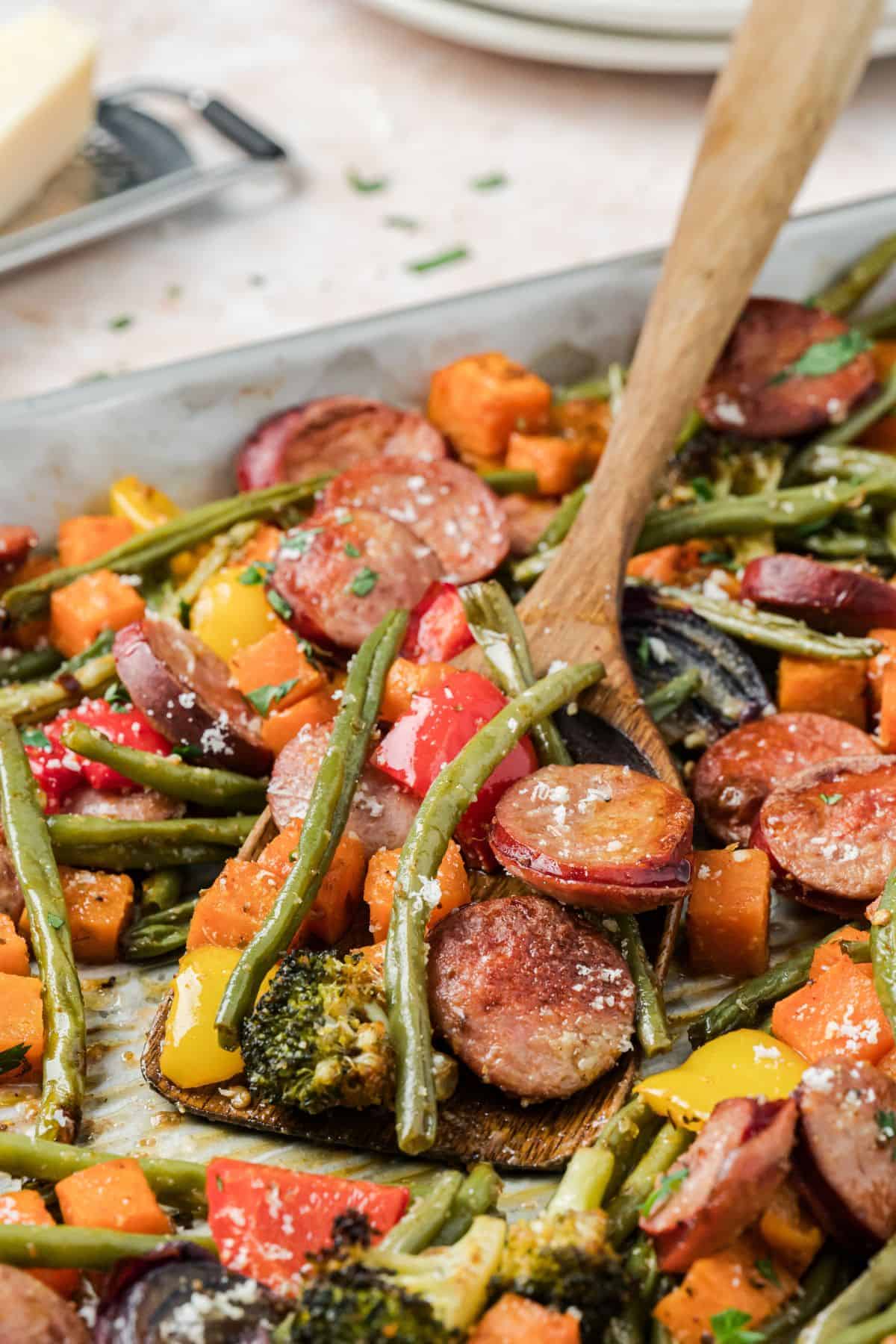 Healthy sheet pan dinner with sausage, broccoli, and roasted root vegetables