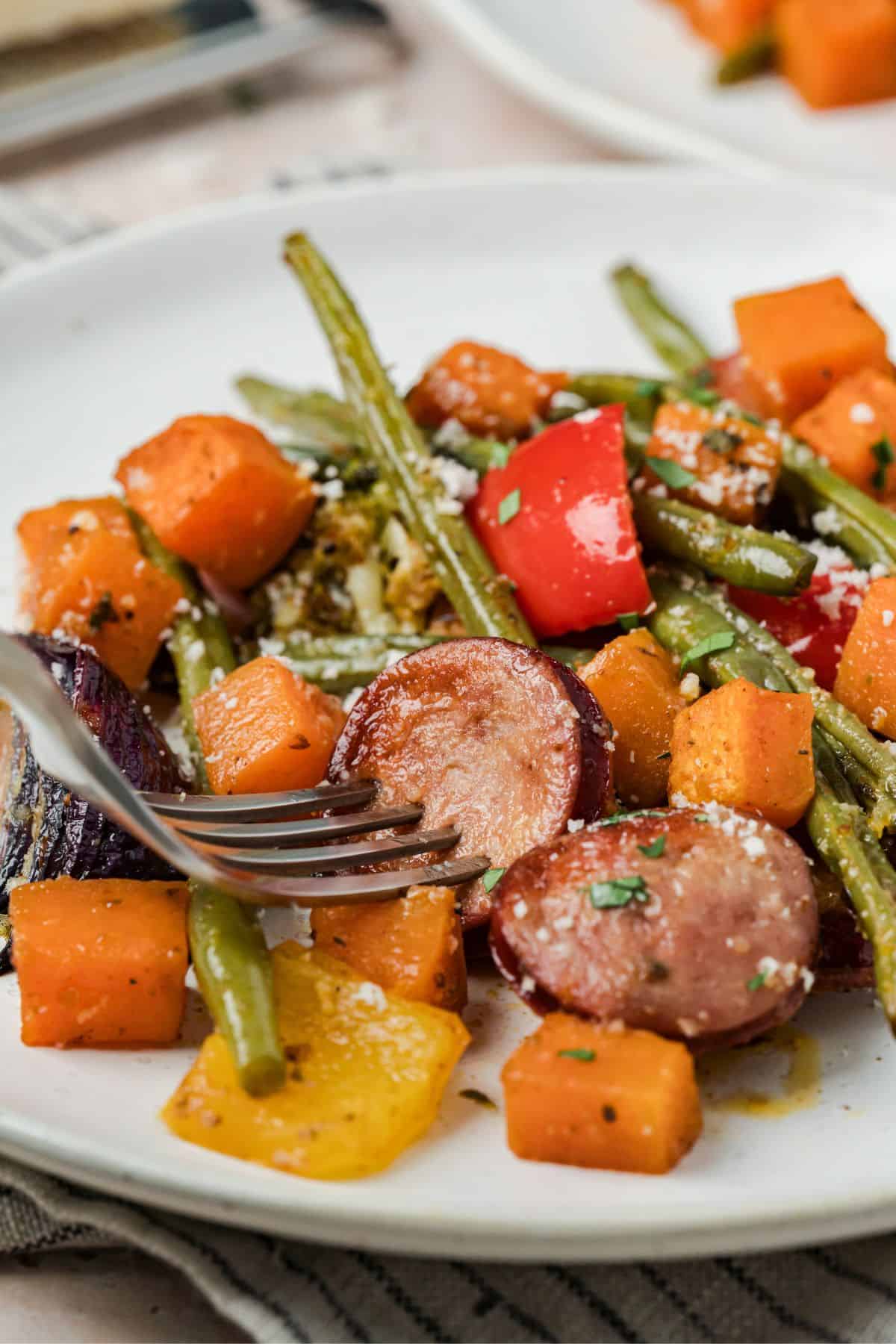 Roasted sausage and vegetable medley topped with fresh parsley and Parmesan