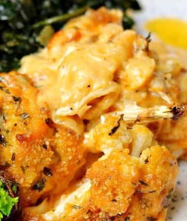 cauliflower Mac and cheese on a plate with collard greens and ribs