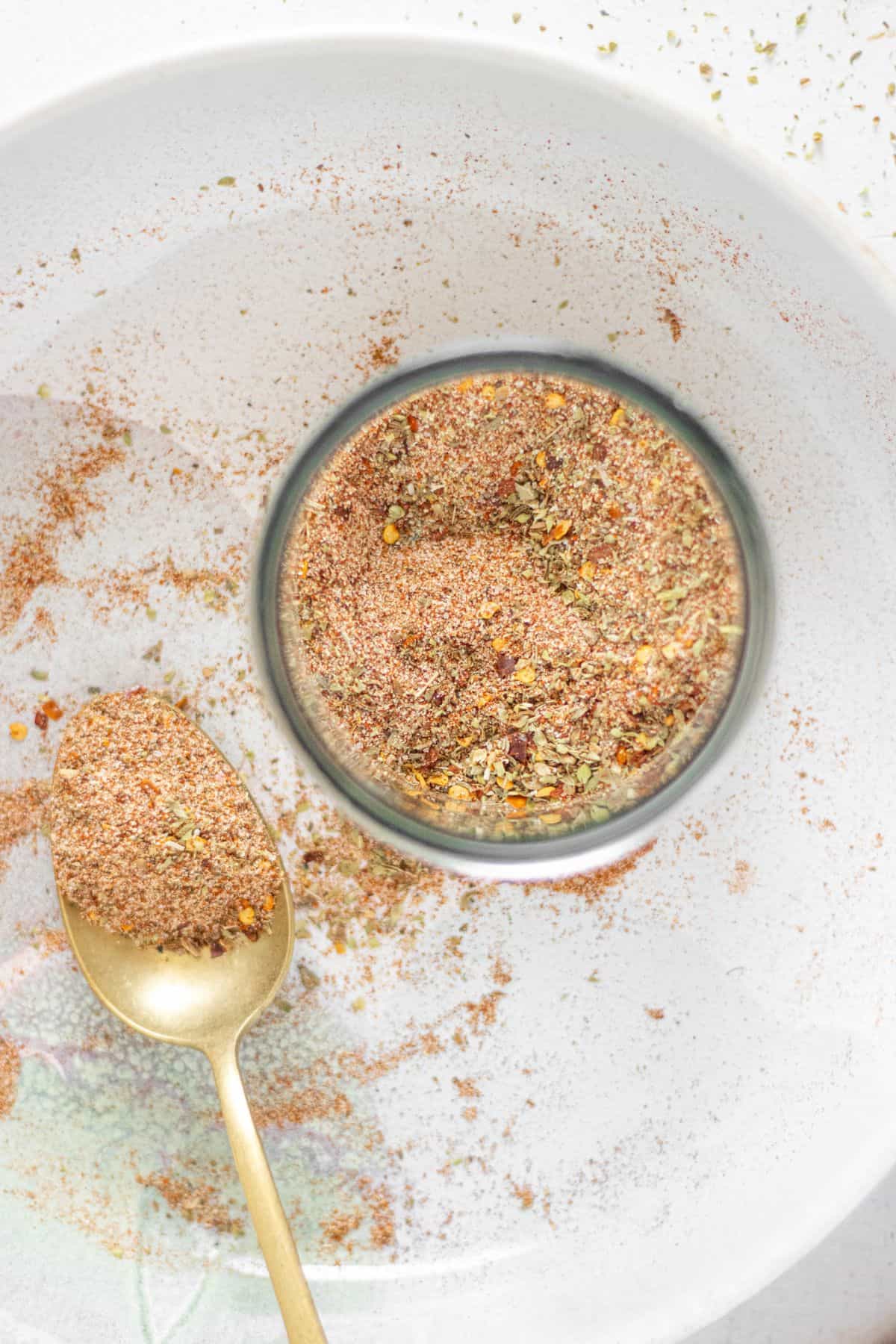 Homemade fajita seasoning in a bowl with a spoon, showing texture and vibrant color