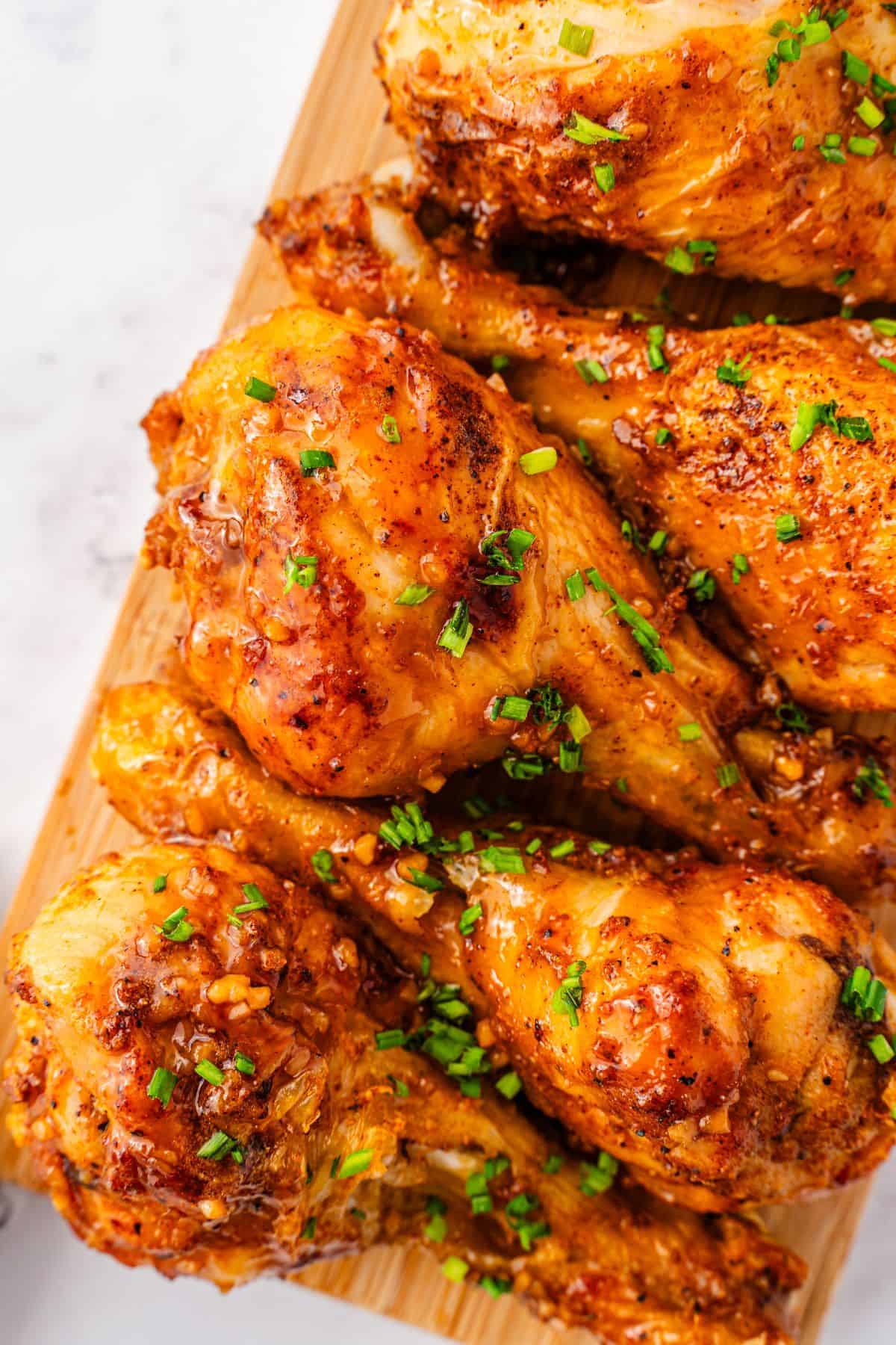 Air fryer chicken drumsticks tossed in buttery honey garlic sauce
