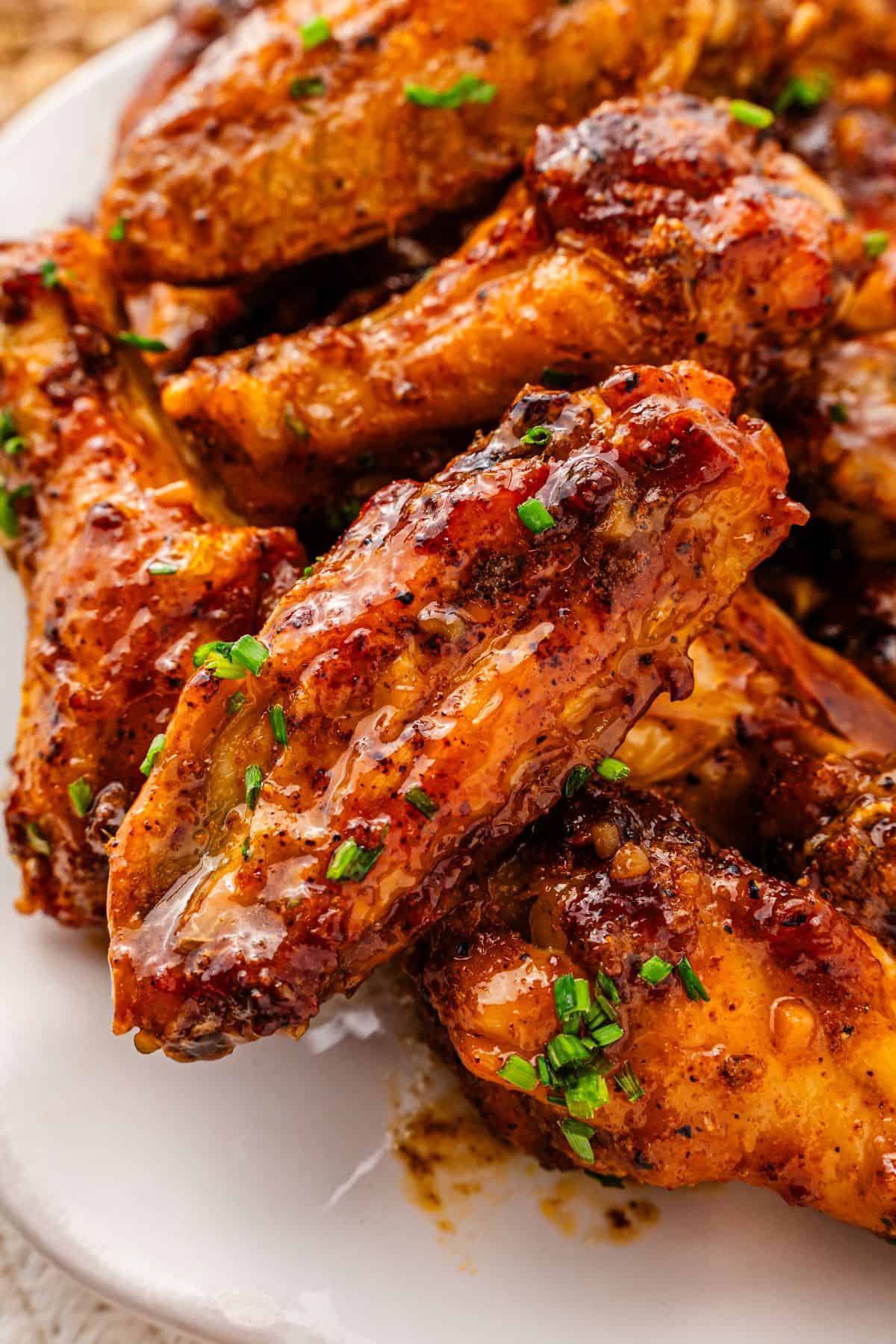 Golden brown chicken wings coated in thick honey garlic glaze