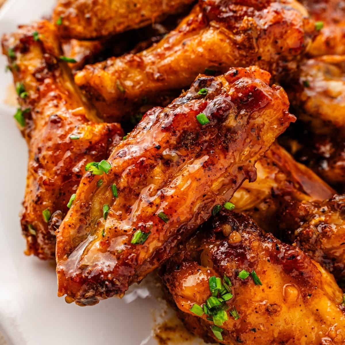 Air fryer honey garlic wings with crispy skin and garlic sauce