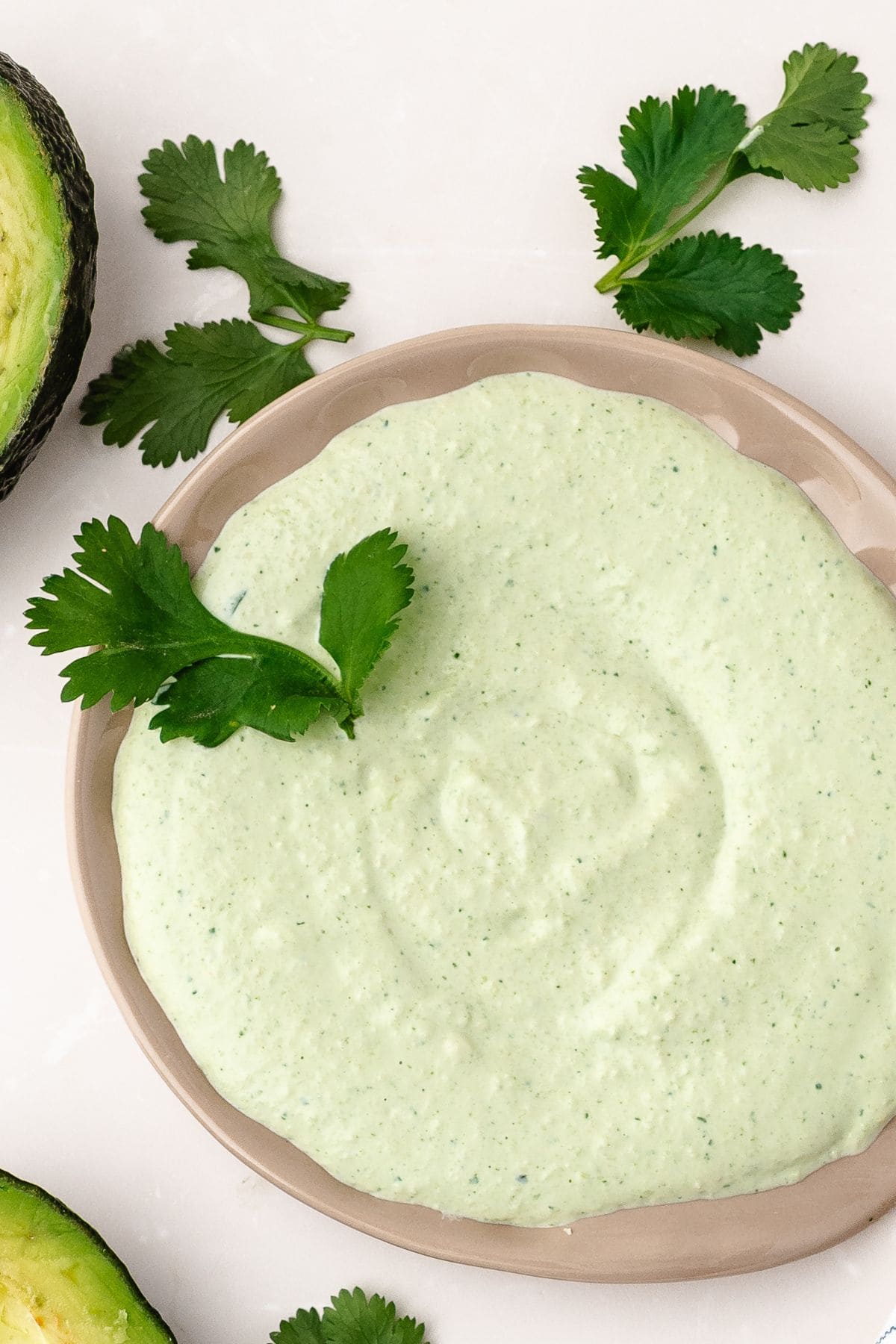 Velvety avocado cream sauce in a bowl, highlighting fresh lime, garlic, and cilantro flavors
