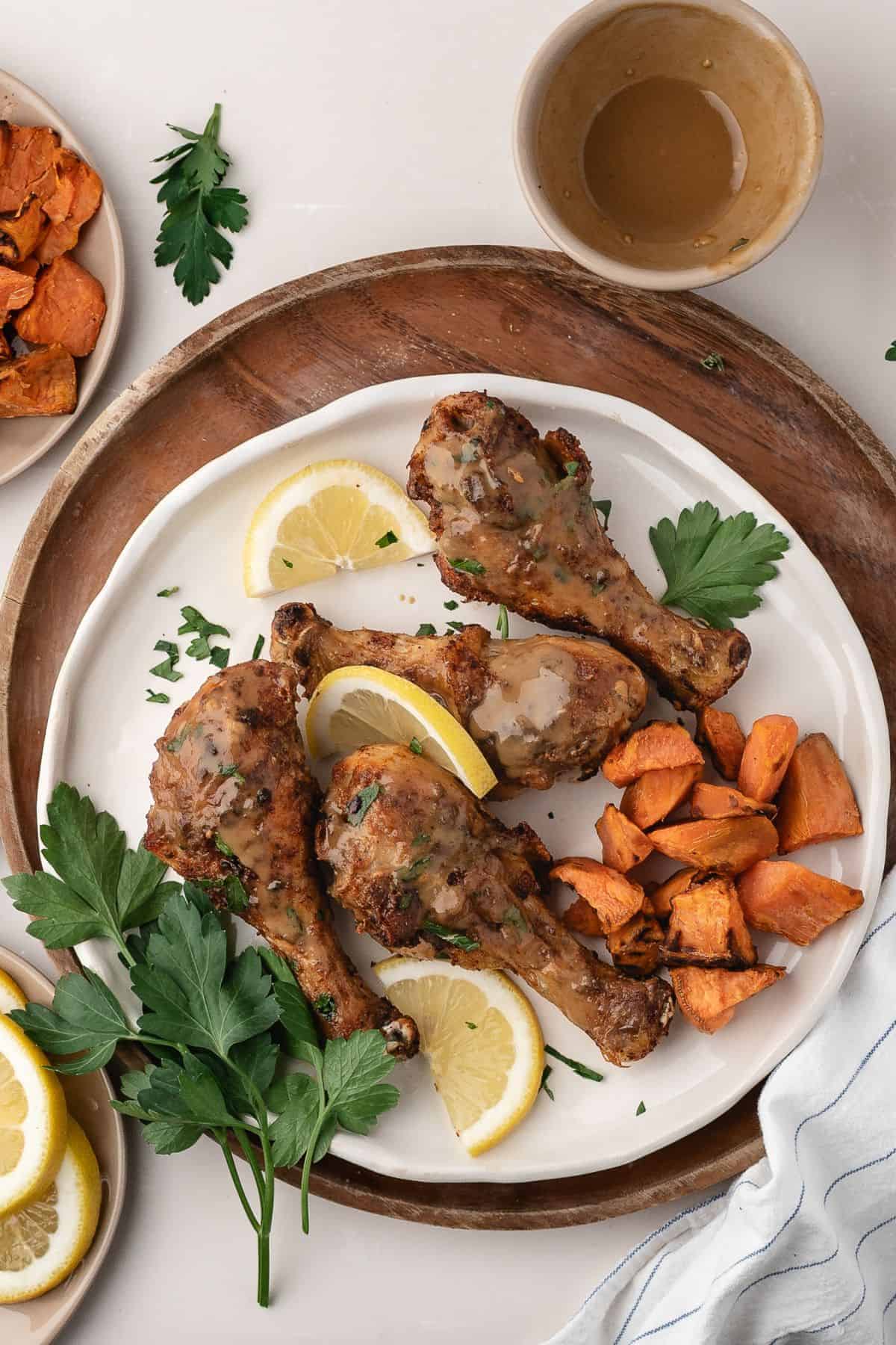 Plate of baked chicken drumsticks showing glossy caramelized edges