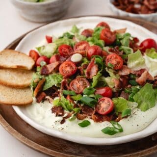 Colorful party dip featuring BLT flavors, creamy base, and crunchy bacon topping