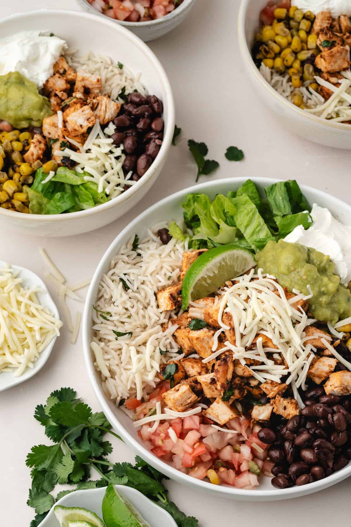Chipotle chicken salad bowl with fresh cilantro and lime garnish