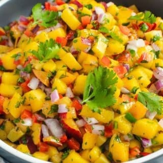 Fresh mango and peach salsa with lime, jalape&ntilde;o, red onion, and cilantro
