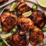 Juicy Peruvian roasted chicken with crispy skin served with slices of lime