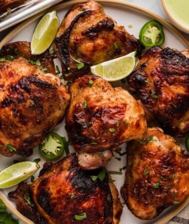 Juicy Peruvian roasted chicken with crispy skin served with slices of lime