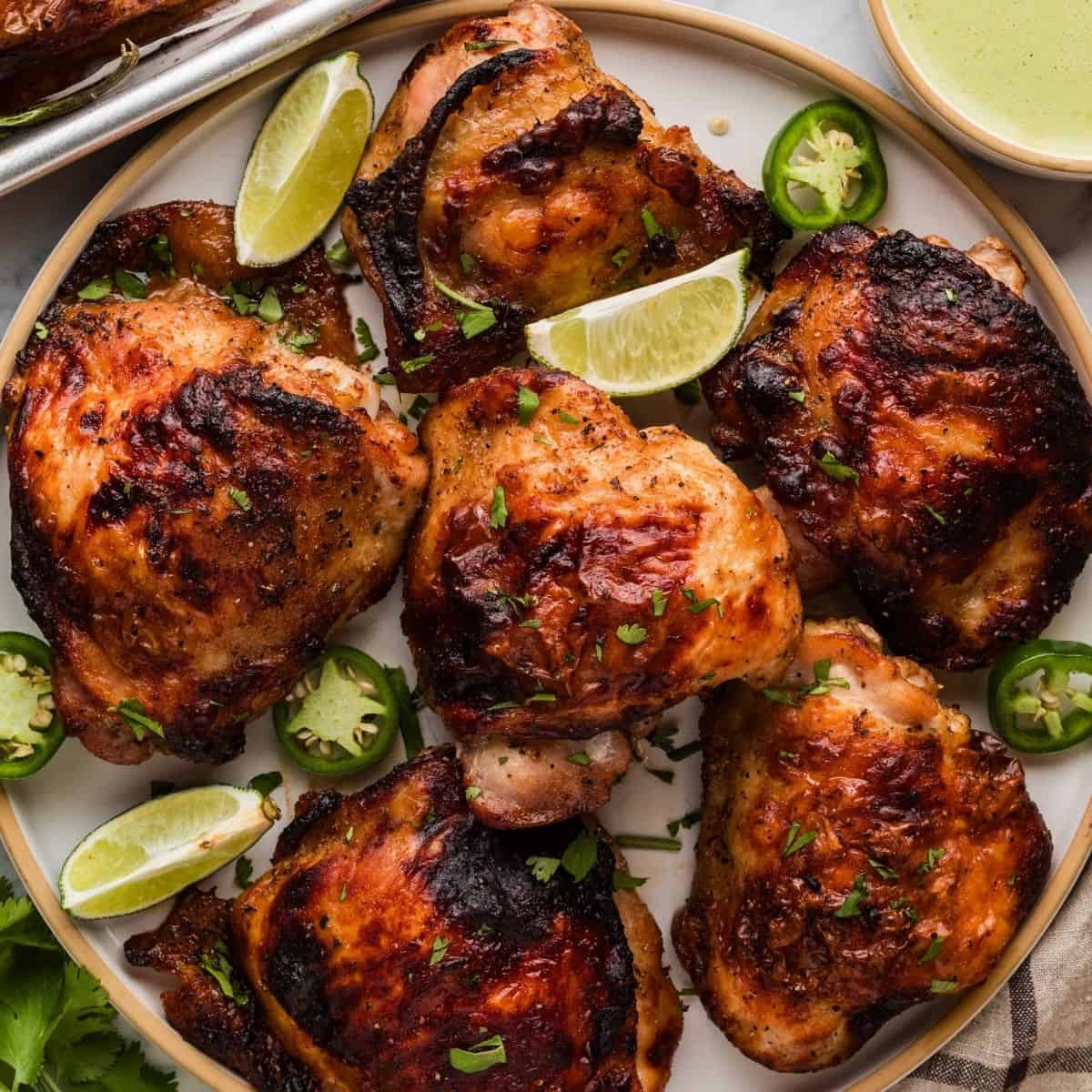 Juicy Peruvian roasted chicken with crispy skin served with slices of lime