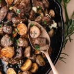 Sizzling steak bites with roasted potato cubes finished with melted blue cheese