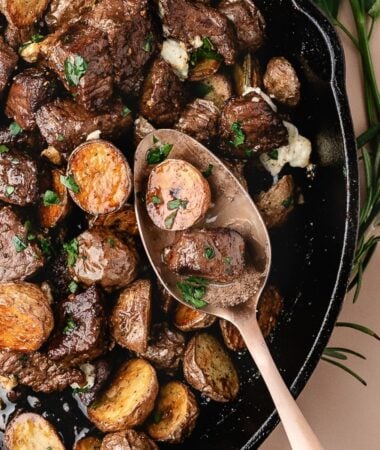 Sizzling steak bites with roasted potato cubes finished with melted blue cheese