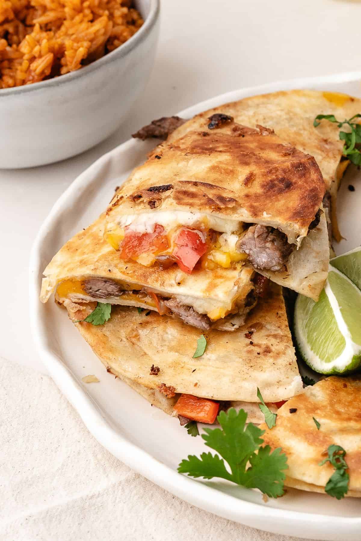 Plated steak quesadilla triangles with a side of sweet-heat jalape&ntilde;o honey sauce
