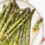 Healthy baked asparagus with crispy tips and cheesy topping