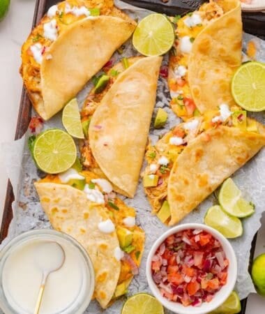 Shredded chicken tacos baked until tortillas are golden and crisp