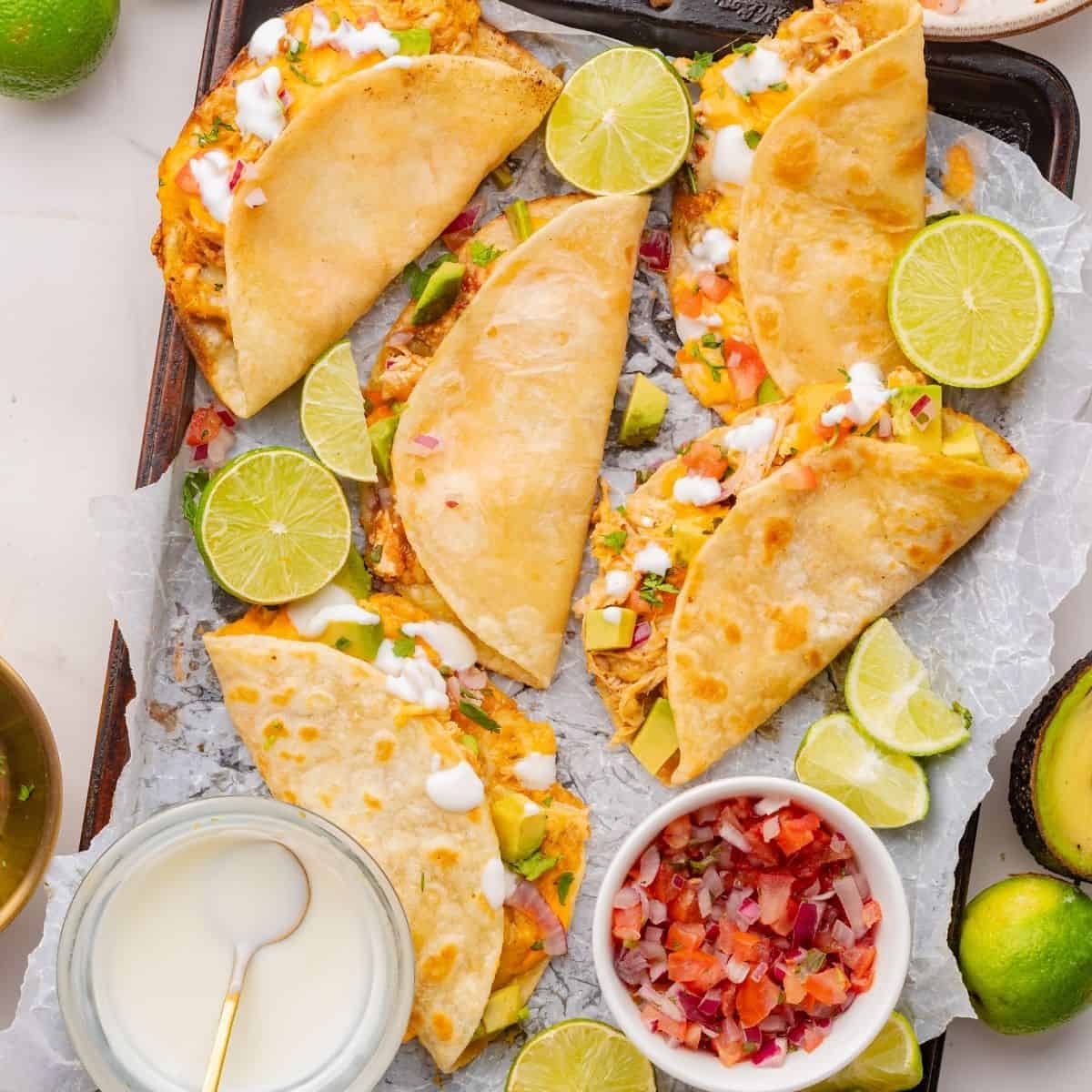 Shredded chicken tacos baked until tortillas are golden and crisp