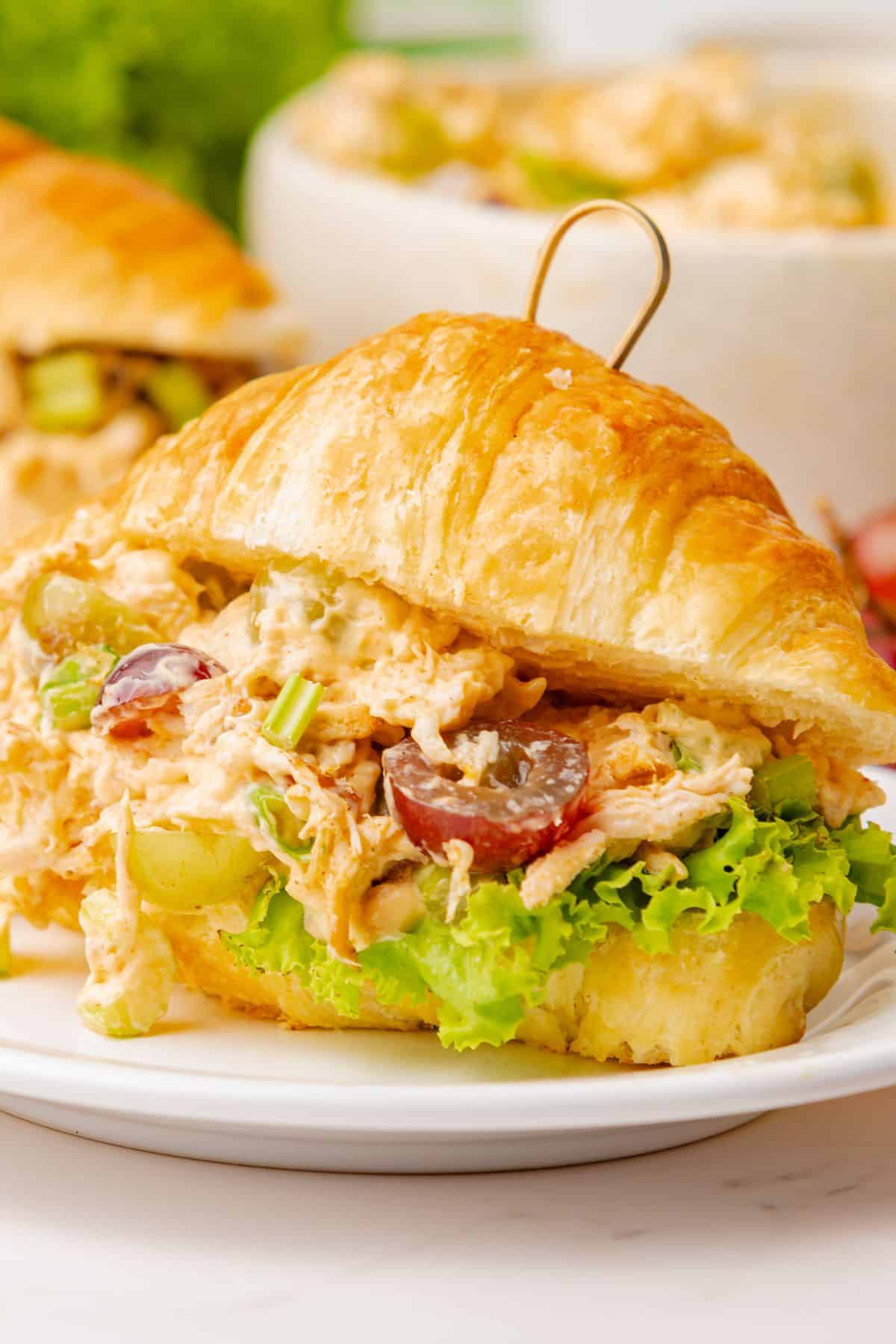Chicken salad croissant sandwich with crunchy celery, grapes, and almonds