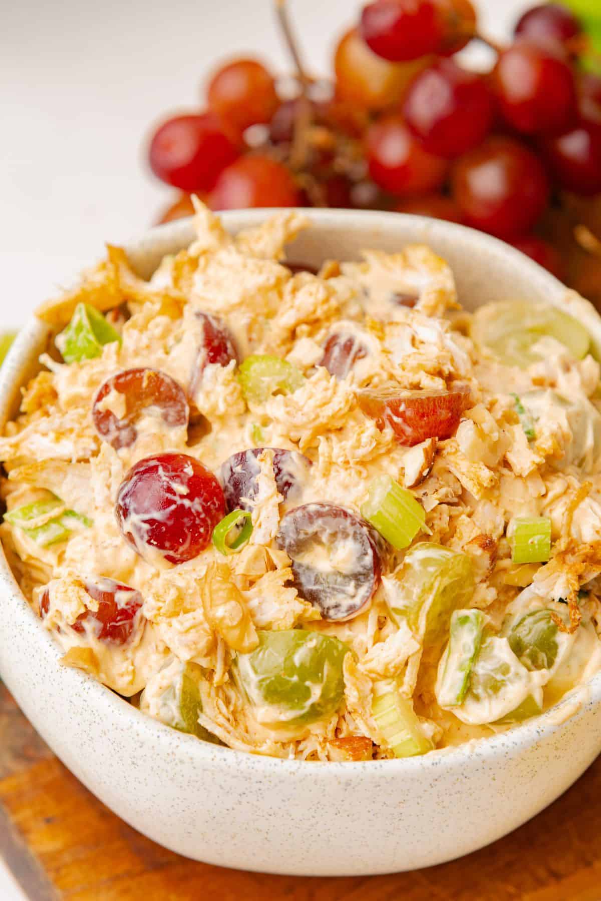 Creamy chicken grape salad piled in a serving bowl