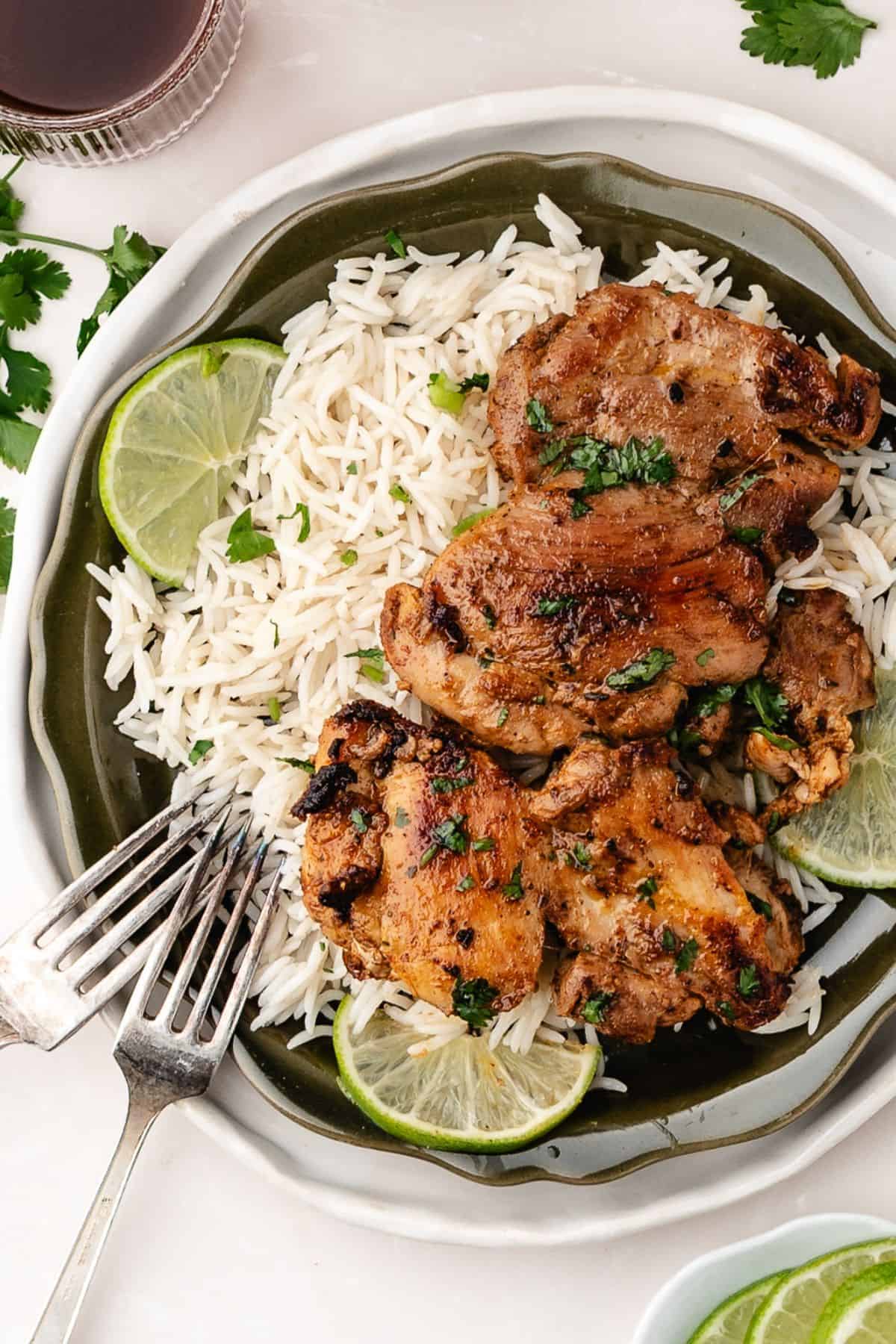 Juicy cilantro lime chicken with charred edges and citrus flavor served with warm rice