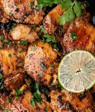 Simple cilantro lime chicken garnished with fresh herbs and lime
