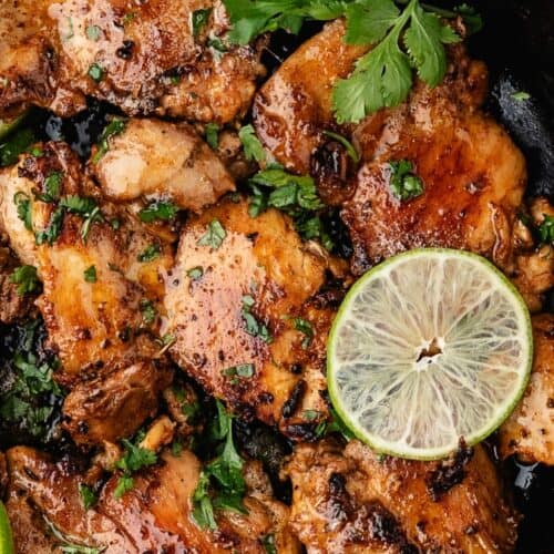 Simple cilantro lime chicken garnished with fresh herbs and lime
