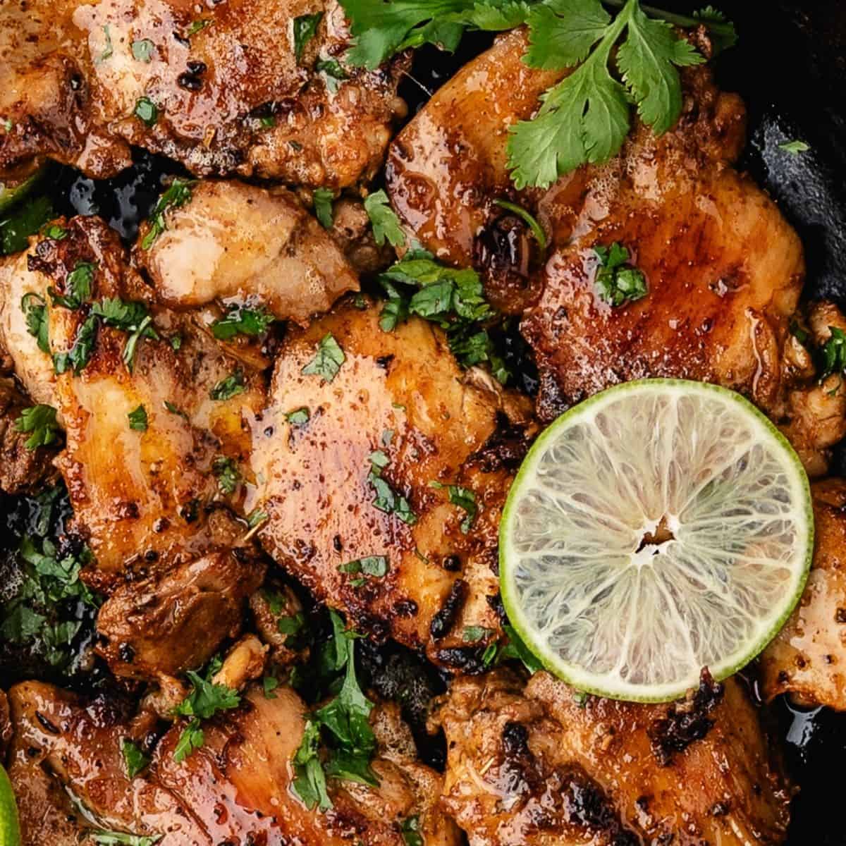 Simple cilantro lime chicken garnished with fresh herbs and lime
