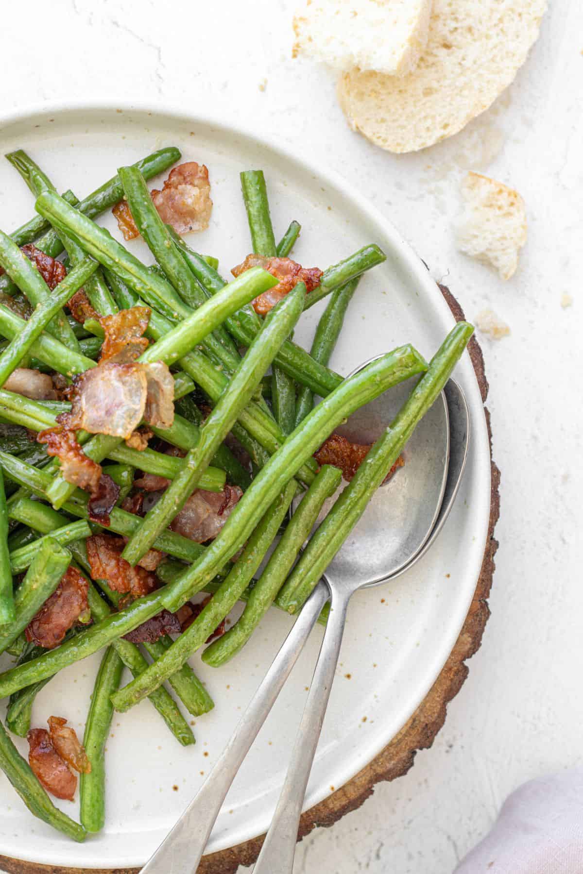 Plate of green beans tossed with crispy bacon bits