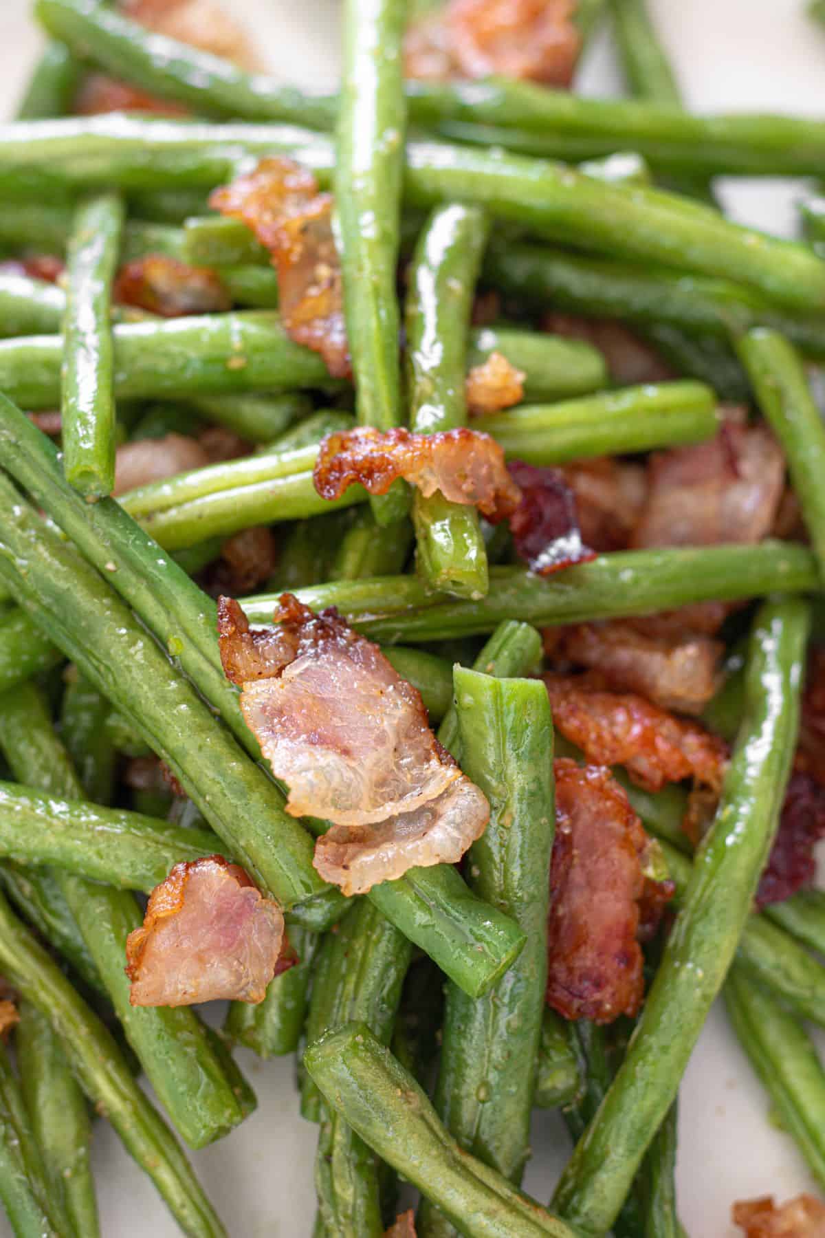 Savory green beans with smoky bacon cooked in a skillet