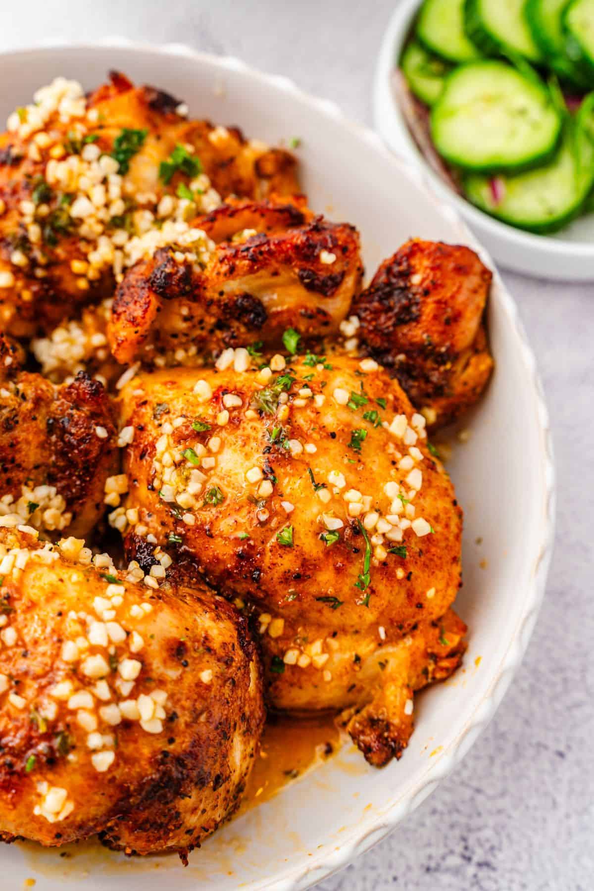 Flavorful lemon garlic chicken thighs plated in a serving bowl