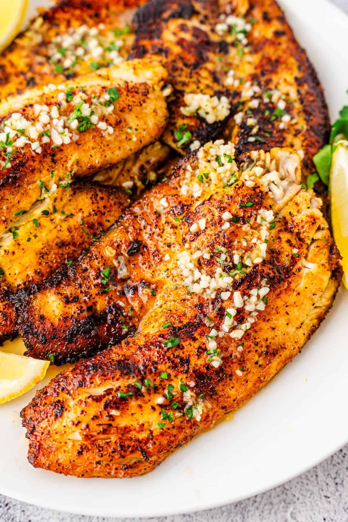 Flaky white fish seared until golden and topped with lemon butter