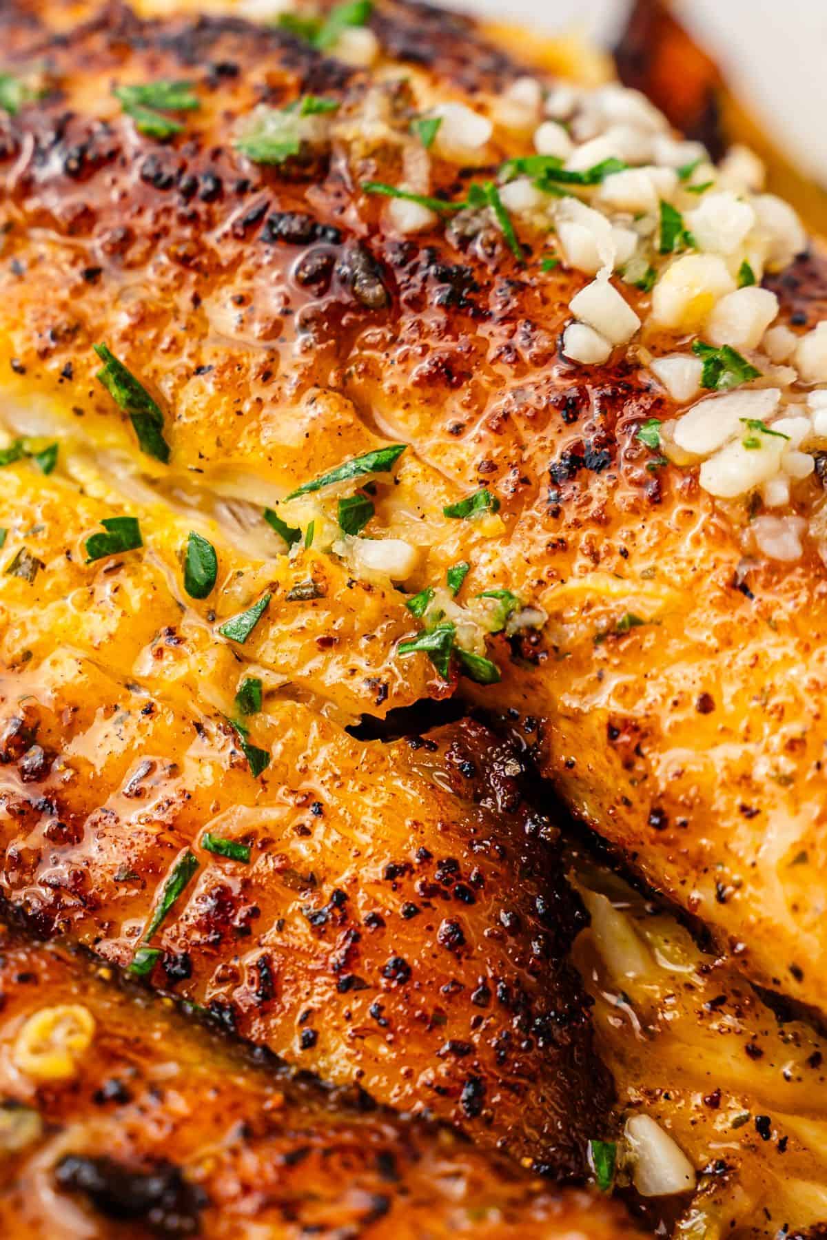 Juicy tilapia fillet cooked in a hot skillet with light seasoning