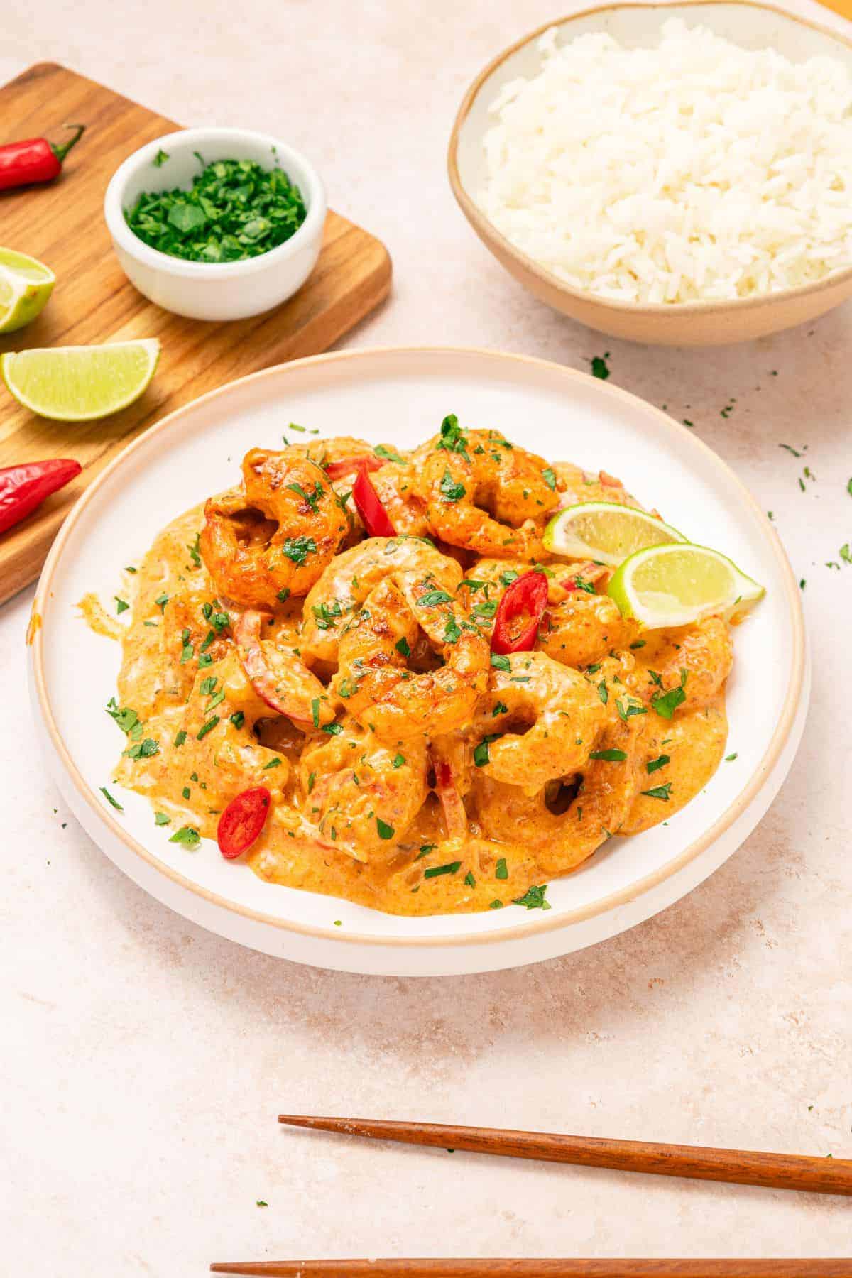 Shrimp cooked in rich coconut red curry sauce with herbs served with warm rice