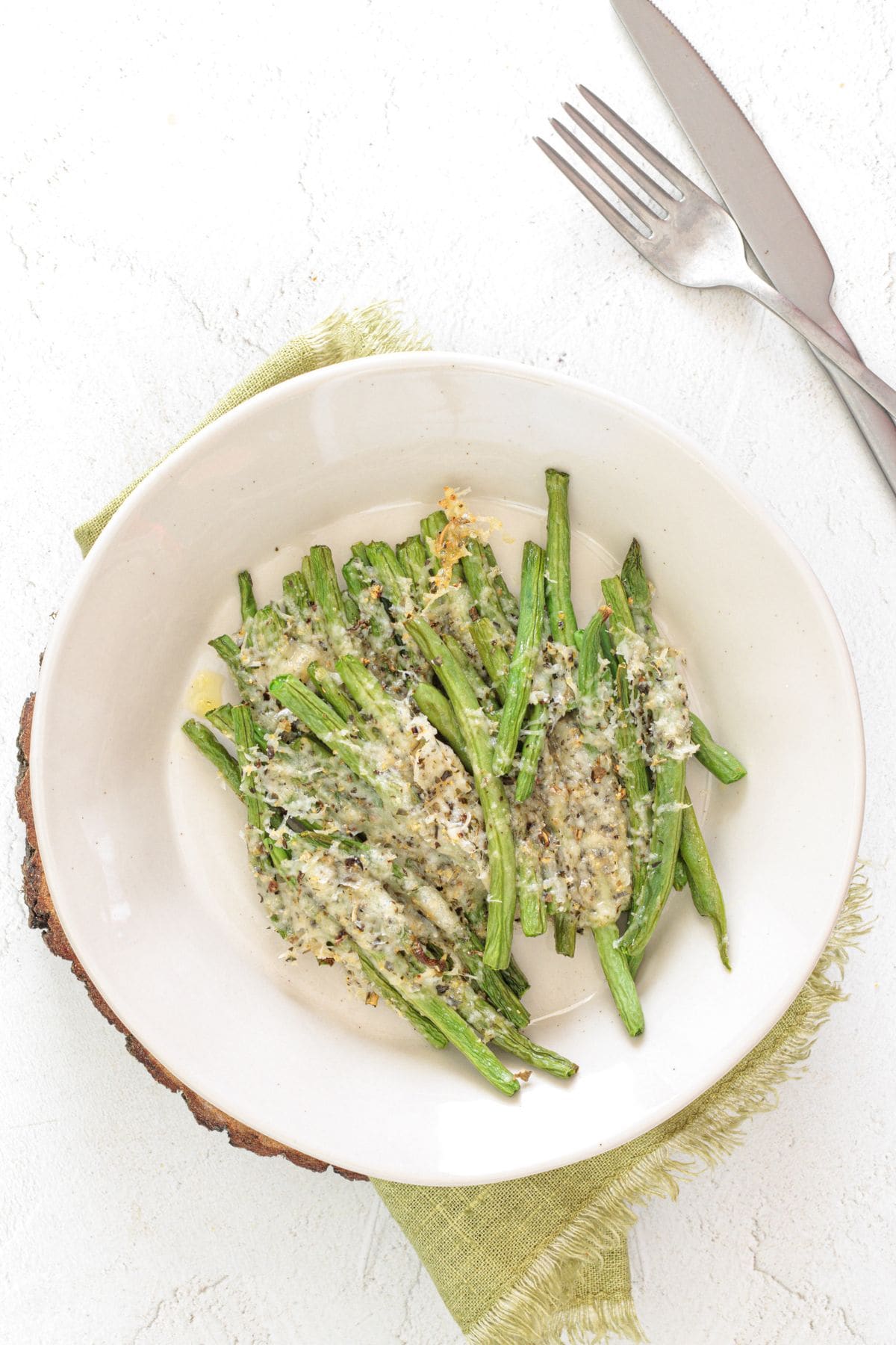 Plate of roasted green beans with lightly browned edges