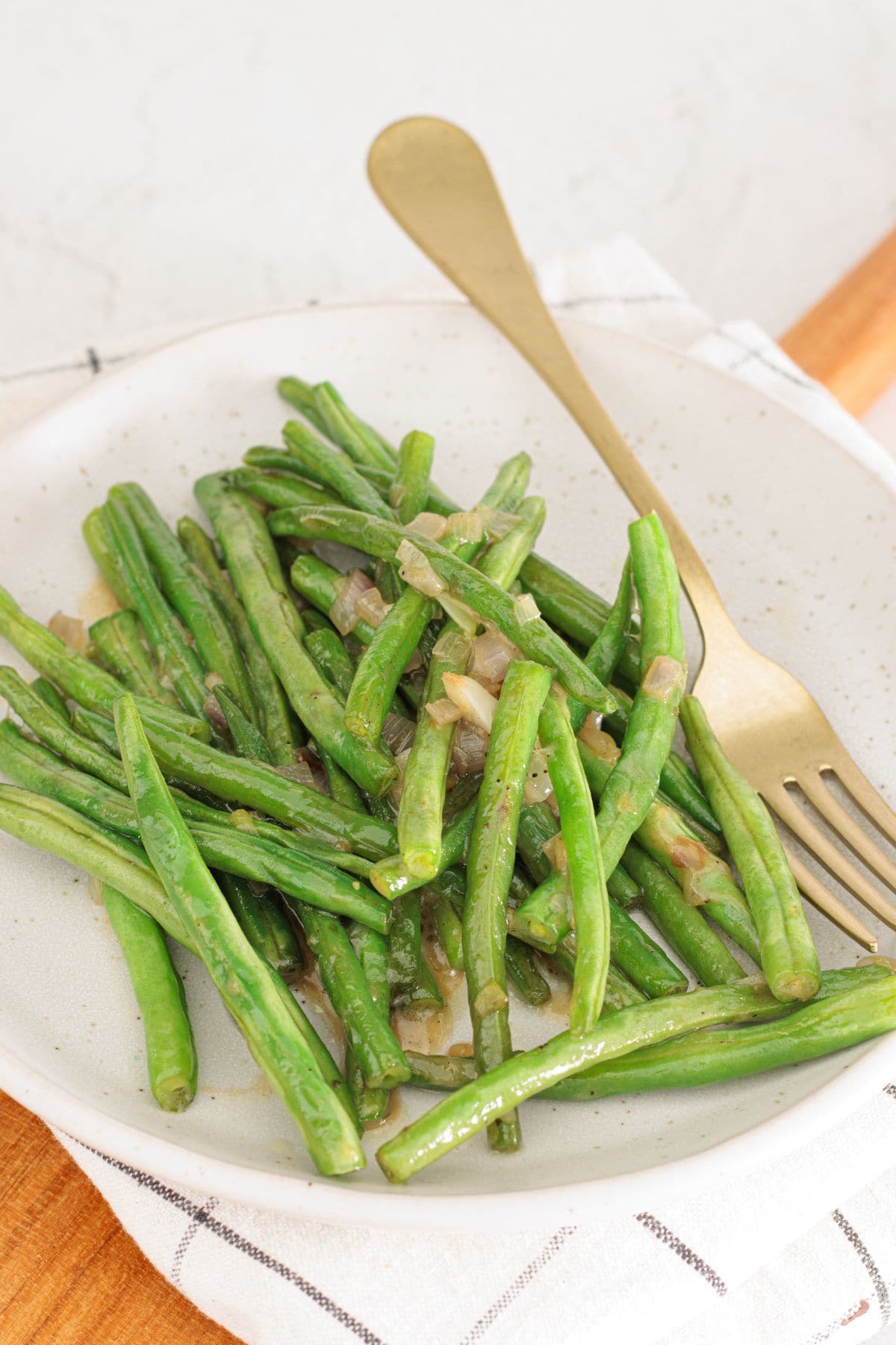 Tender green beans cooked in butter and flavored with shallots