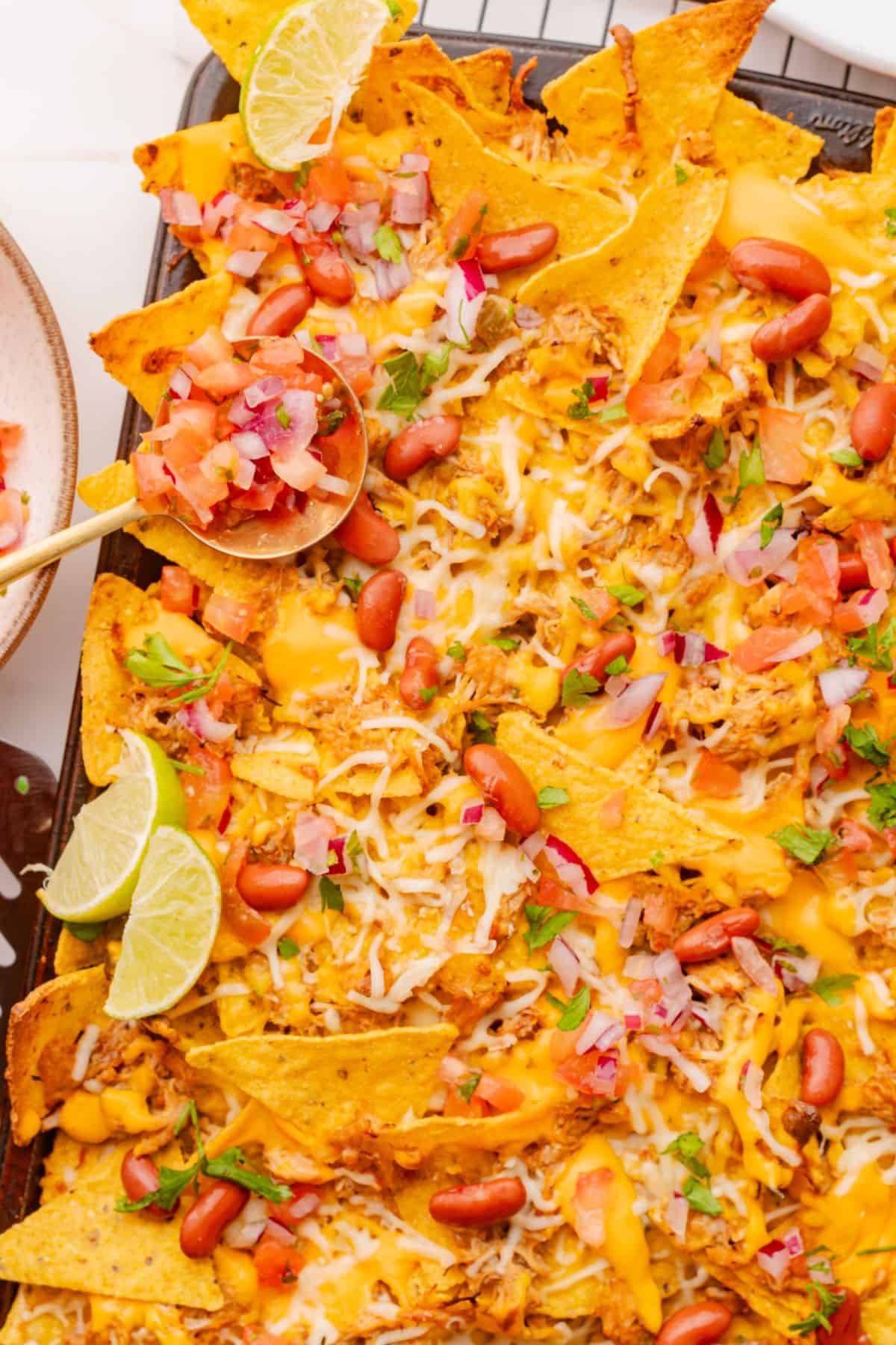 Mexican chicken nachos topped with seasoned shredded chicken