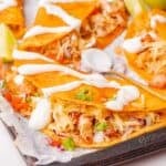 Flavorful chicken tacos with tender shredded filling inside crispy shells