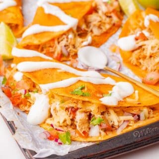 Flavorful chicken tacos with tender shredded filling inside crispy shells
