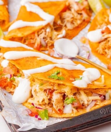 Flavorful chicken tacos with tender shredded filling inside crispy shells