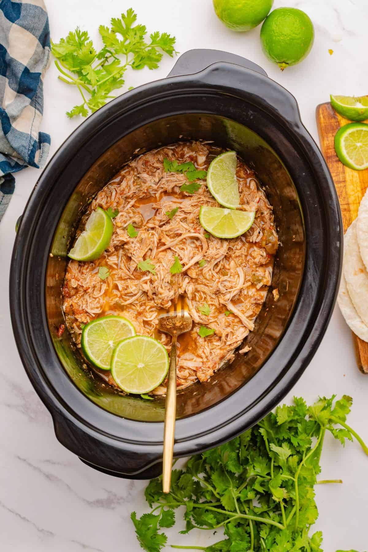 Crockpot Mexican shredded chicken with bold taco seasoning and lime flavor