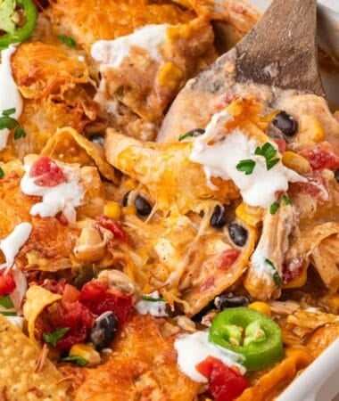 Shredded chicken Mexican casserole topped with chips and baked until golden