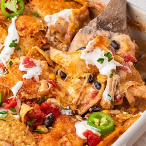 Shredded chicken Mexican casserole topped with chips and baked until golden