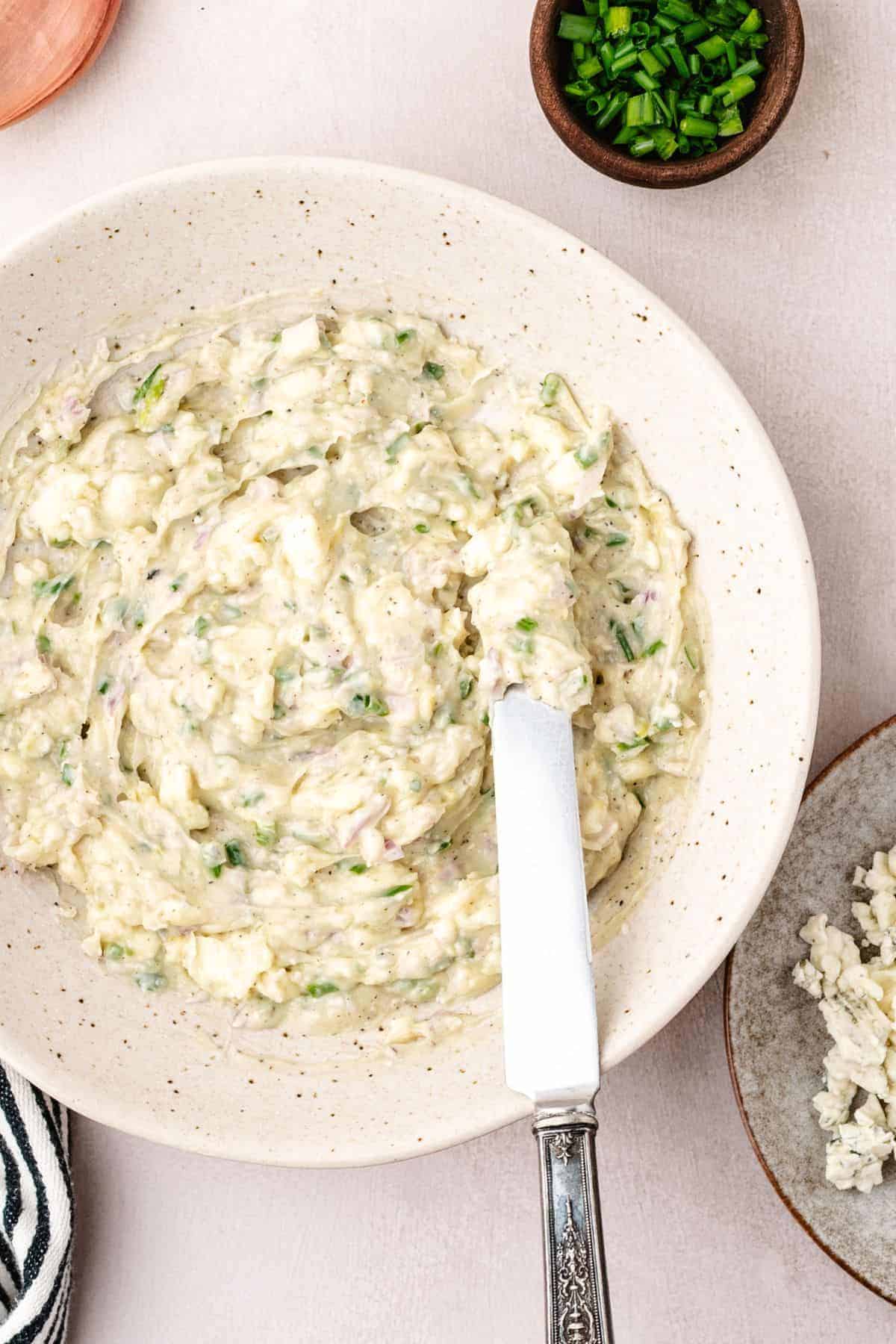 Blue cheese compound butter with creamy texture and herb garnish