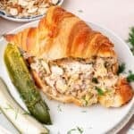 Dill pickle chicken salad recipe served as a croissant sandwich
