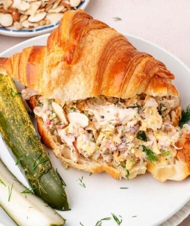 Dill pickle chicken salad recipe served as a croissant sandwich
