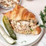 Dill pickle chicken salad recipe served as a croissant sandwich