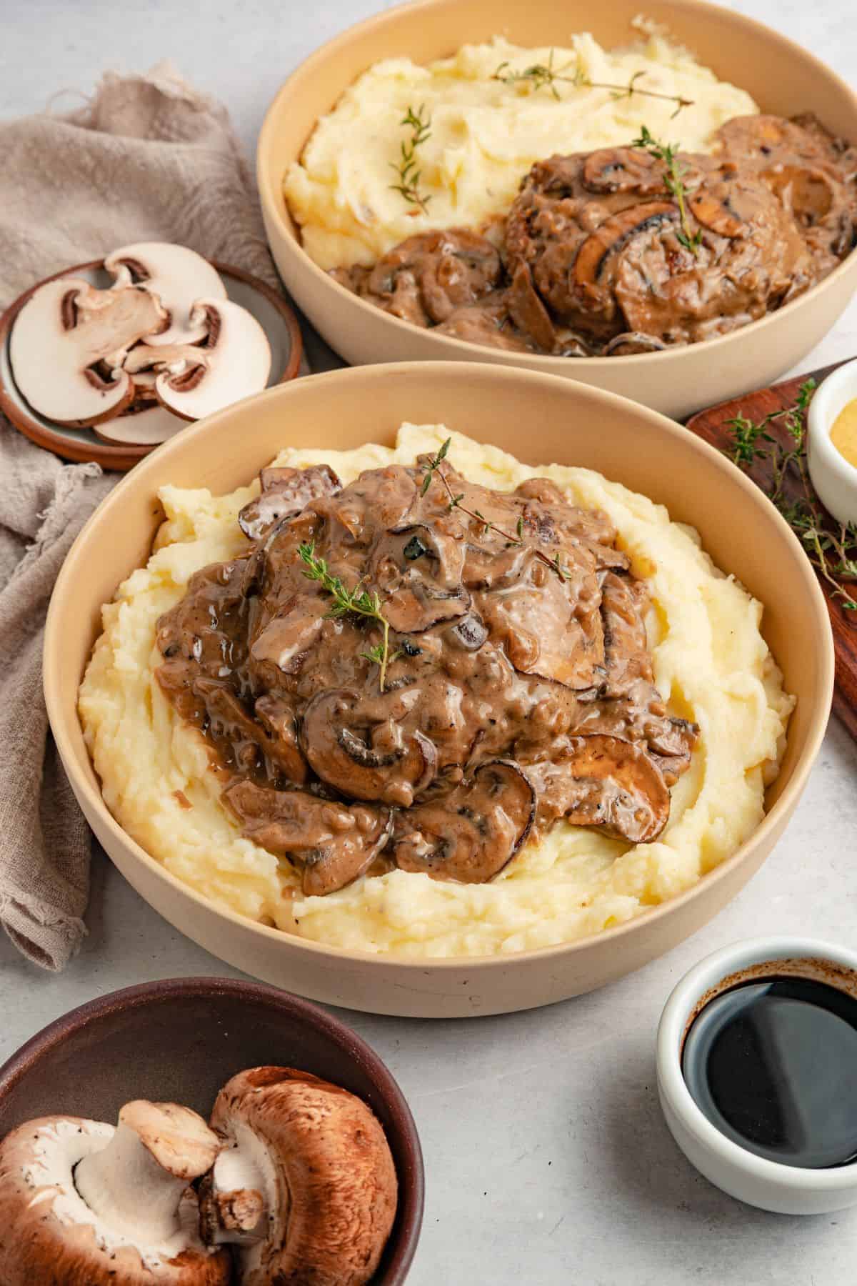 Oven baked hamburger steaks served with mashed potatoes and rich brown gravy