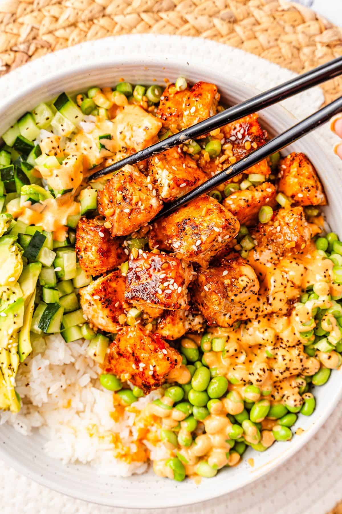 Teriyaki salmon rice bowls topped with cucumber and avocado