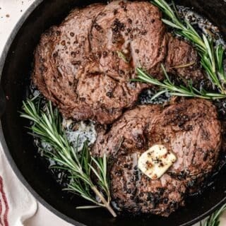 Cast iron pan seared steak with crispy browned edges and juicy center